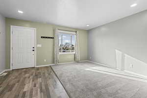 Entrance foyer featuring dark wood-style flooring, recessed lighting, and a textured ceiling