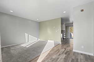 Carpeted empty room featuring recessed lighting and wood finished floors