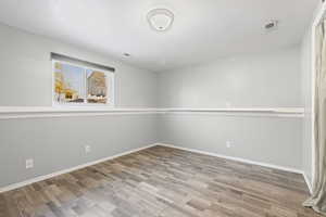 Spare room featuring a textured ceiling and light wood-style flooring