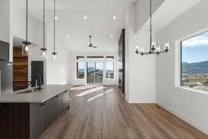 Kitchen with decorative light fixtures, a mountain view, open floor plan, ceiling fan, and high vaulted ceiling