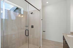 Bathroom featuring vanity, a shower stall, and recessed lighting