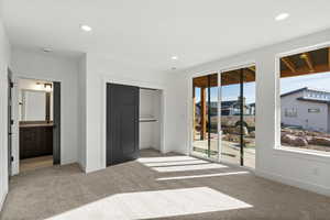 Carpeted bedroom with a closet, access to outside, recessed lighting, and ensuite bathroom