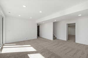 Unfurnished bedroom featuring recessed lighting and light colored carpet