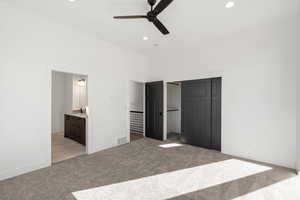 Unfurnished bedroom with a closet, light colored carpet, ceiling fan, and recessed lighting