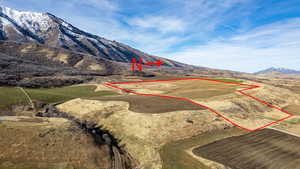 Aerial view of property's location featuring a mountainous background and property boundaries highlighted