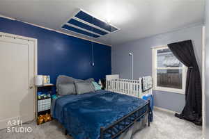 Carpeted bedroom with baseboards