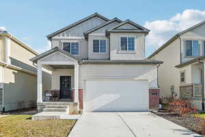 Craftsman-style home with board and batten siding, driveway, stucco siding, a porch, and a garage