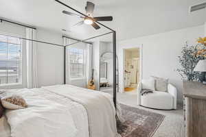 Bedroom featuring carpet flooring, ceiling fan, and ensuite bathroom