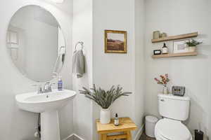Bathroom featuring toilet and baseboards