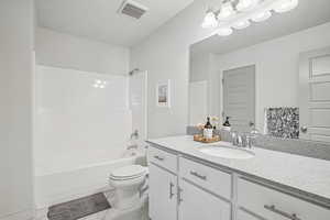Full bathroom with vanity, bathing tub / shower combination, and light marble finish flooring