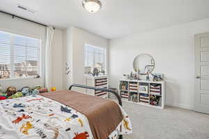 Carpeted bedroom featuring baseboards
