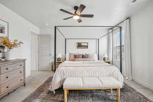 Carpeted bedroom with ceiling fan and baseboards