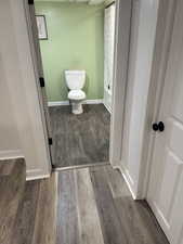 Bathroom featuring dark wood finished floors and shower / tub combo with curtain
