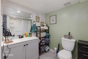 Bathroom featuring vanity, a shower with curtain, light tile patterned floors, and recessed lighting