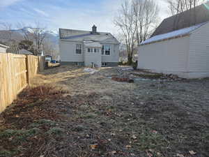 Back of property featuring a chimney and a mountain view