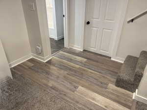 Hallway with baseboards and dark wood-style floors
