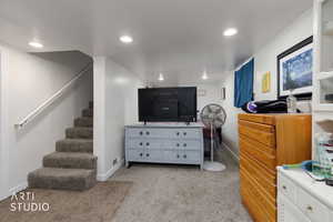 Bedroom with light carpet and recessed lighting