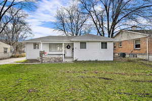 Bungalow-style home with a shingled roof and covered porch