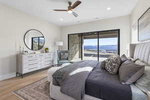 Bedroom with access to outside, wood finished floors, ceiling fan, and recessed lighting