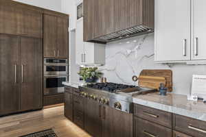Kitchen with dark brown cabinets and appliances with stainless steel finishes