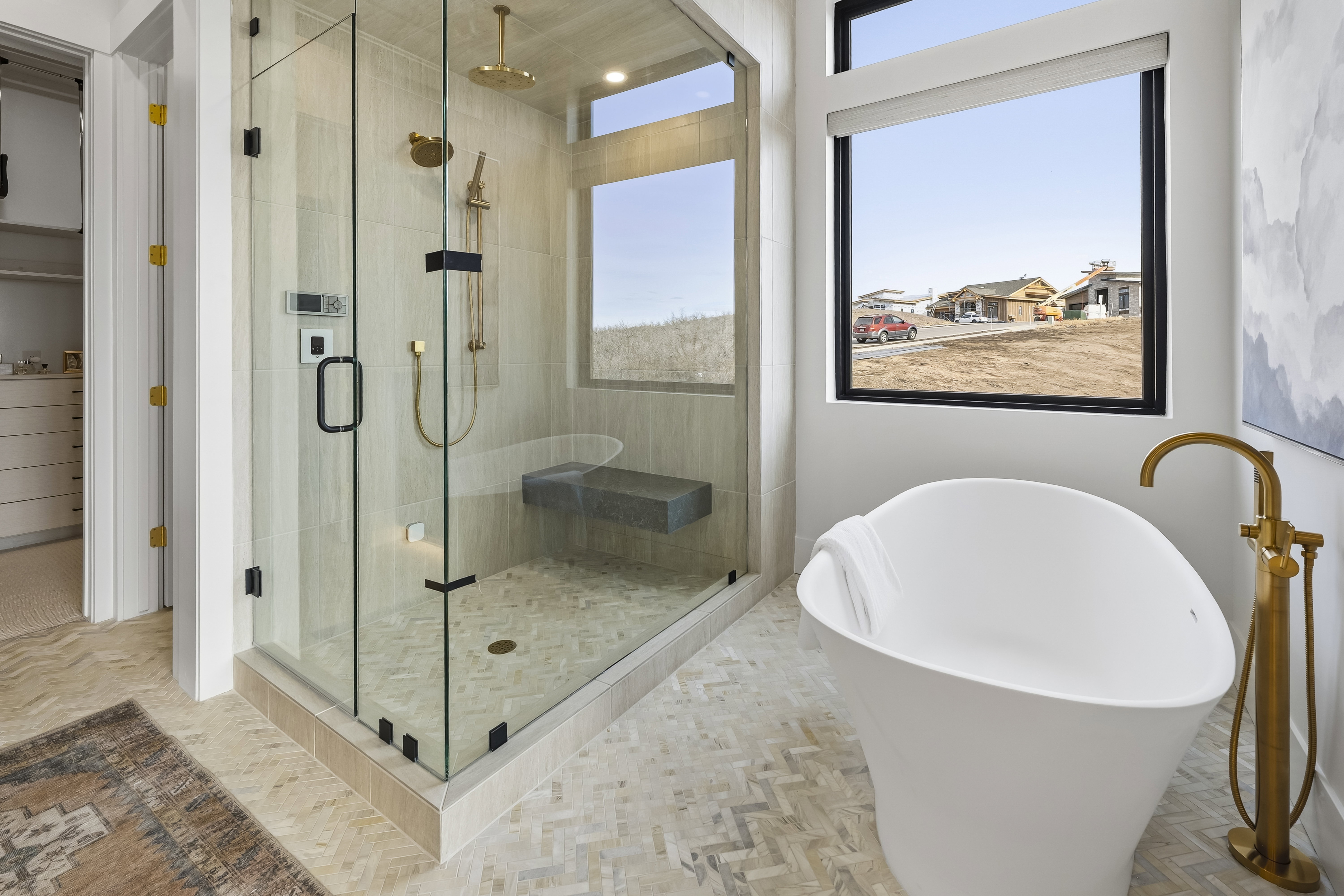 Full bath featuring a soaking tub, a shower stall, and a walk in closet