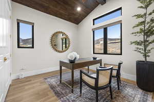 Office featuring light wood-style floors, vaulted ceiling, wood ceiling, recessed lighting, and a mountain view