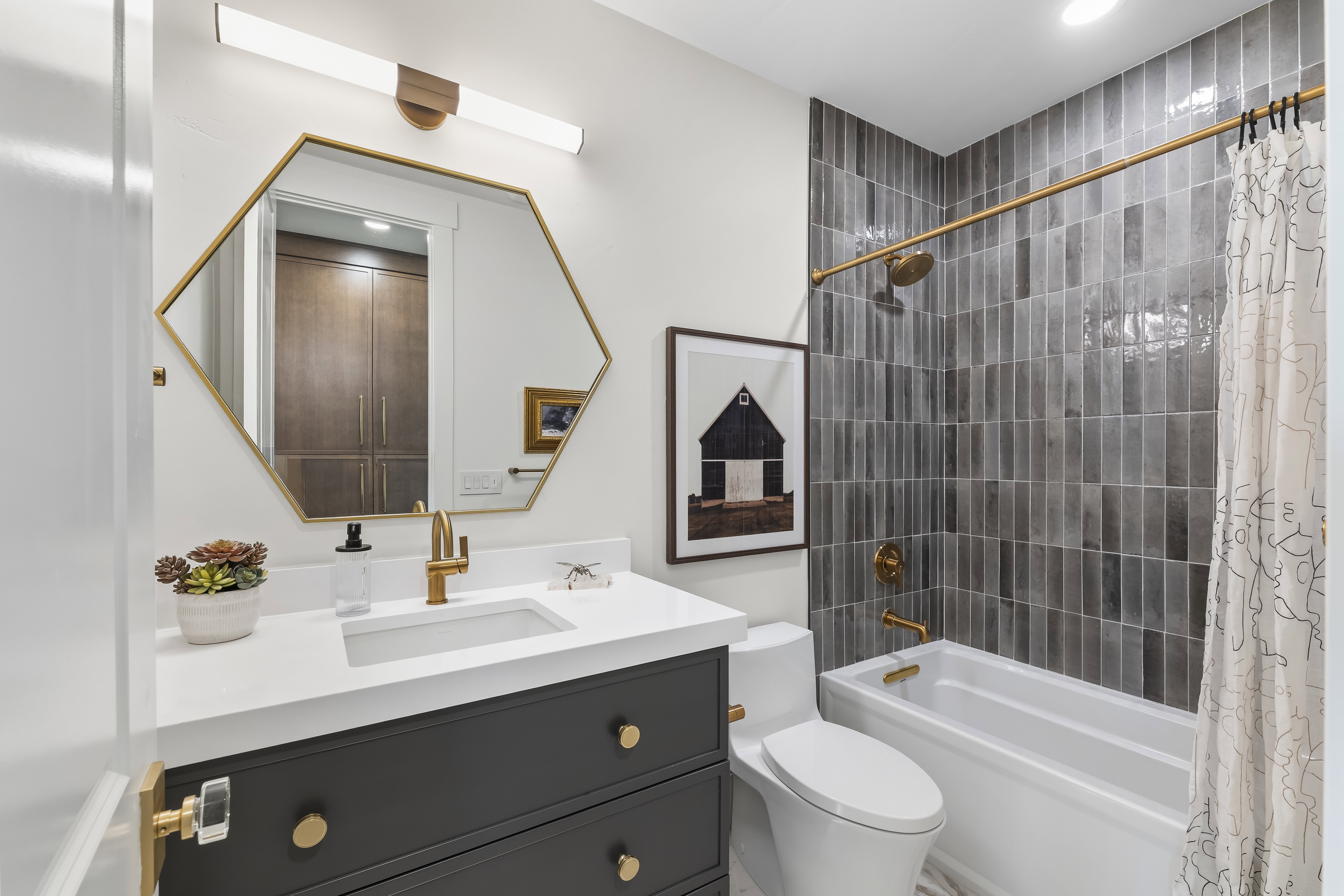 Full bathroom with shower / bath combo with shower curtain and vanity