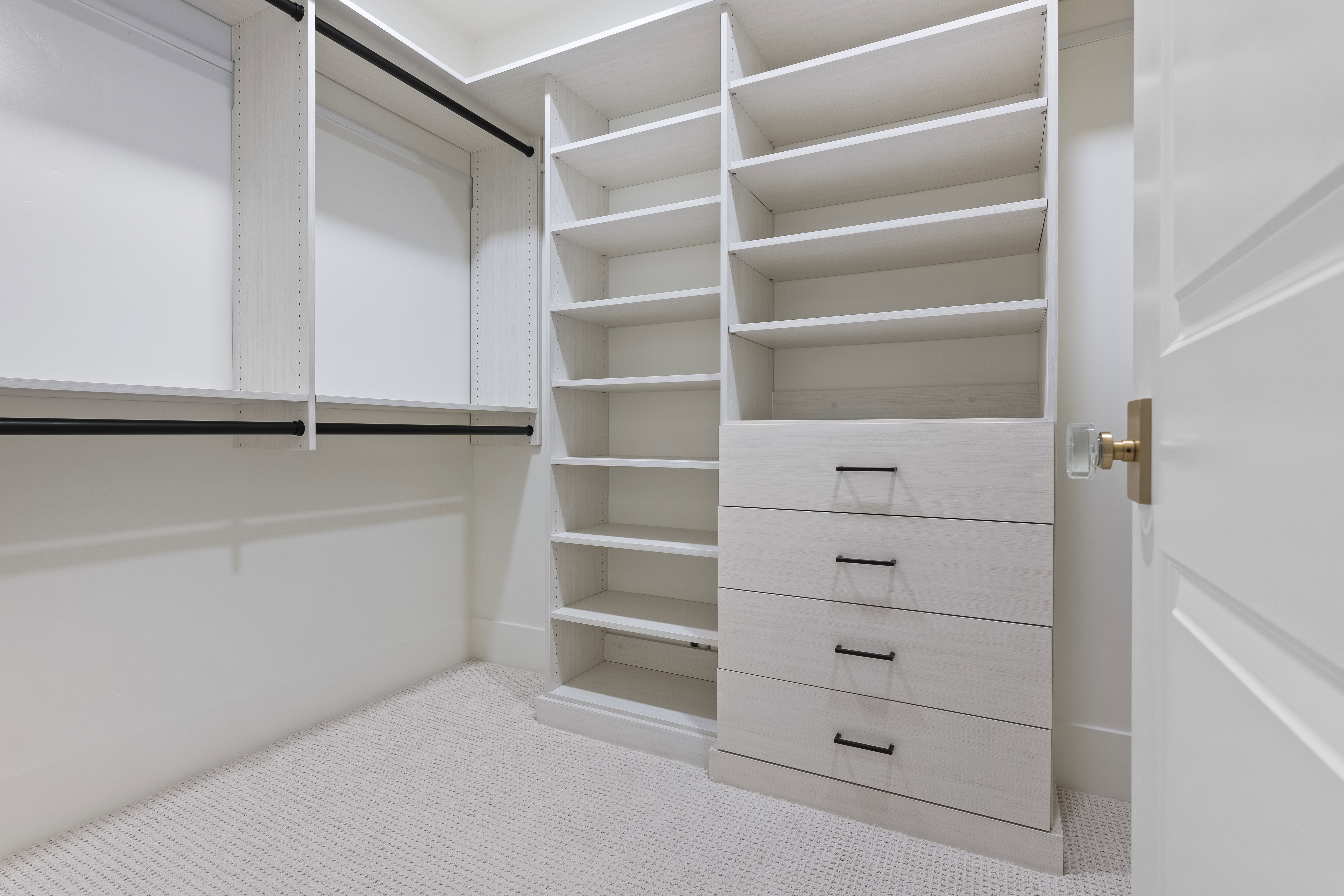 Walk in closet with light carpet