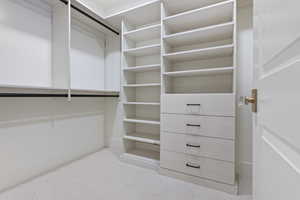 Walk in closet with light carpet