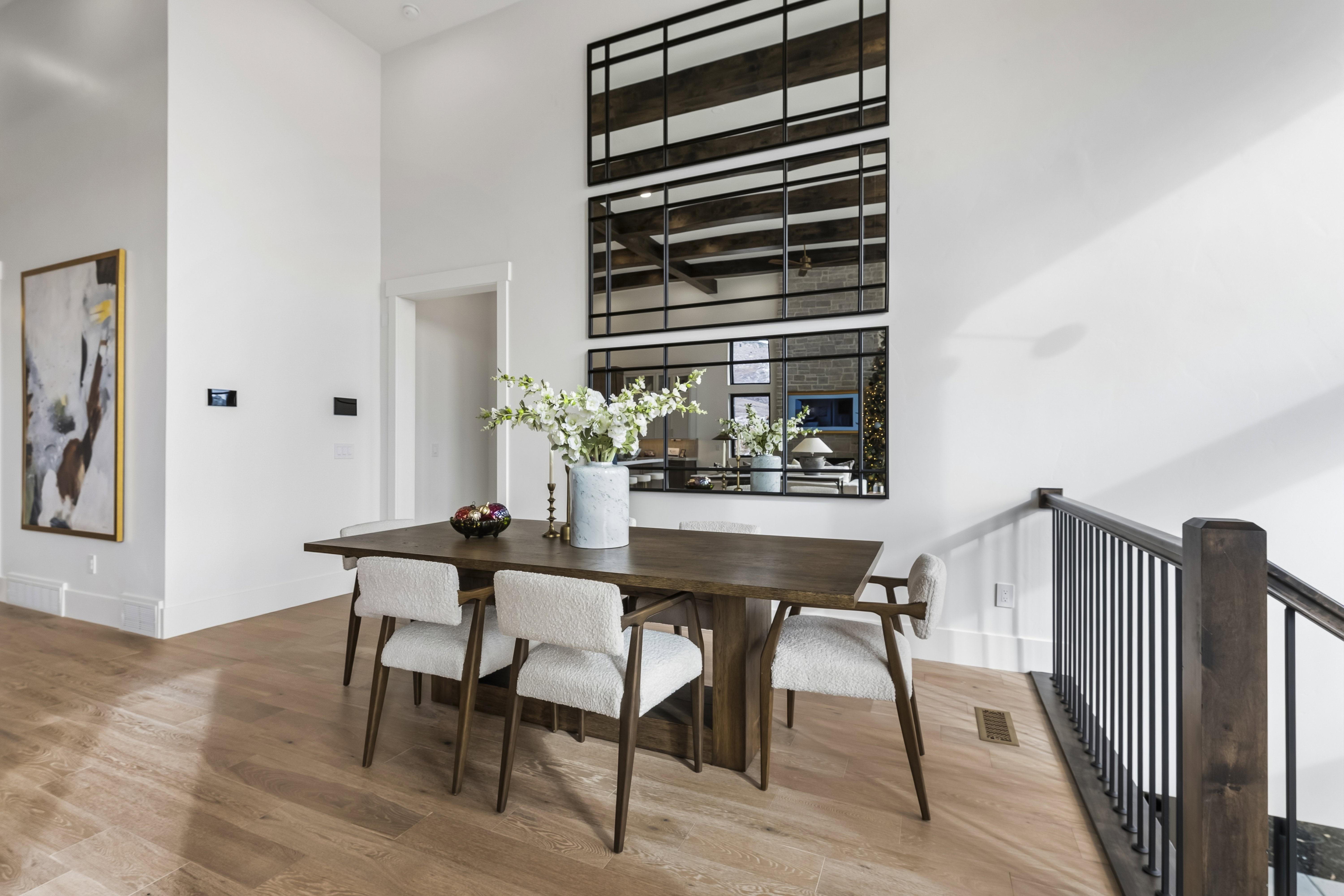 Dining area with a towering ceiling and light wood-type flooring