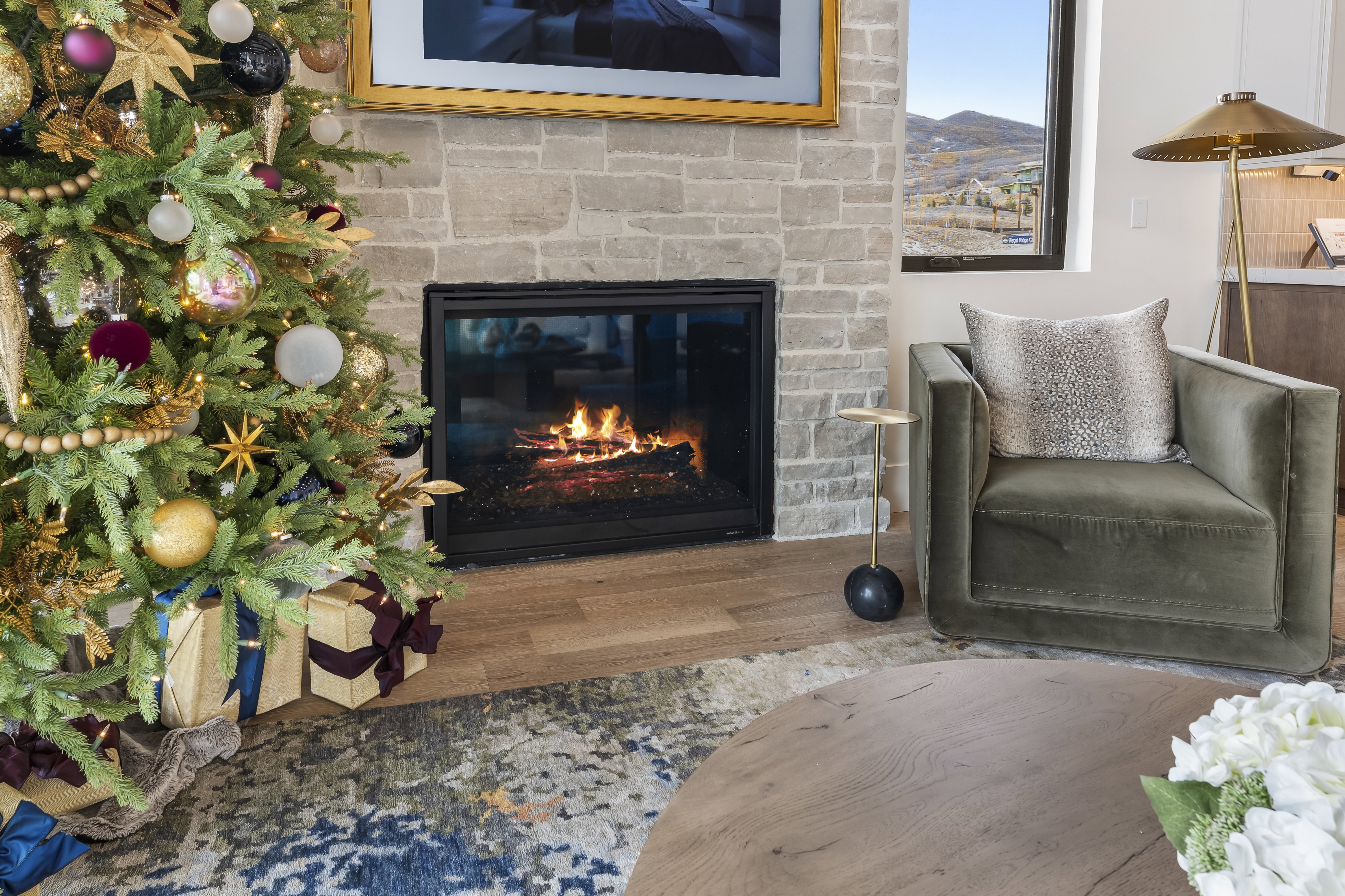 Living area featuring wood finished floors and a glass covered fireplace