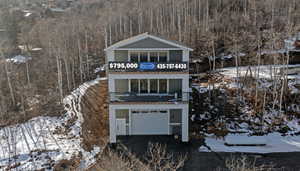 View of front of house featuring a balcony and a garage