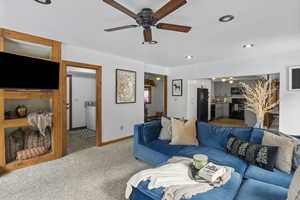 Carpeted living room with recessed lighting, a ceiling fan, and washer / clothes dryer