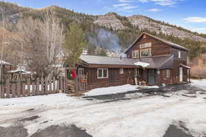 View of front of home with a mountain view and a metal roof
