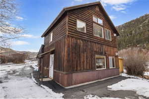 View of snowy exterior with a mountain view