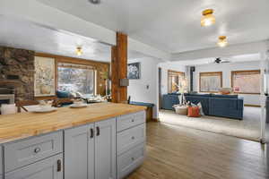 Kitchen with open floor plan, wooden counters, gray cabinetry, dark wood-style floors, and a textured ceiling