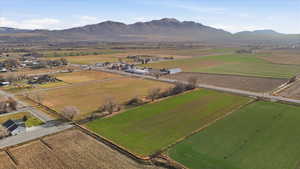 Aerial overview of property's location featuring farmland, rural landscape, and a mountain backdrop