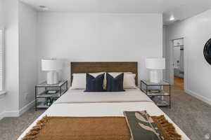 Carpeted bedroom with baseboards