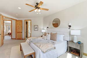 Bedroom with carpet floors, connected bathroom, ceiling fan, and recessed lighting