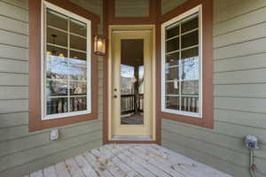 Doorway to property with a deck