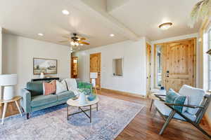 Living area featuring recessed lighting, wood finished floors, ceiling fan, and beam ceiling