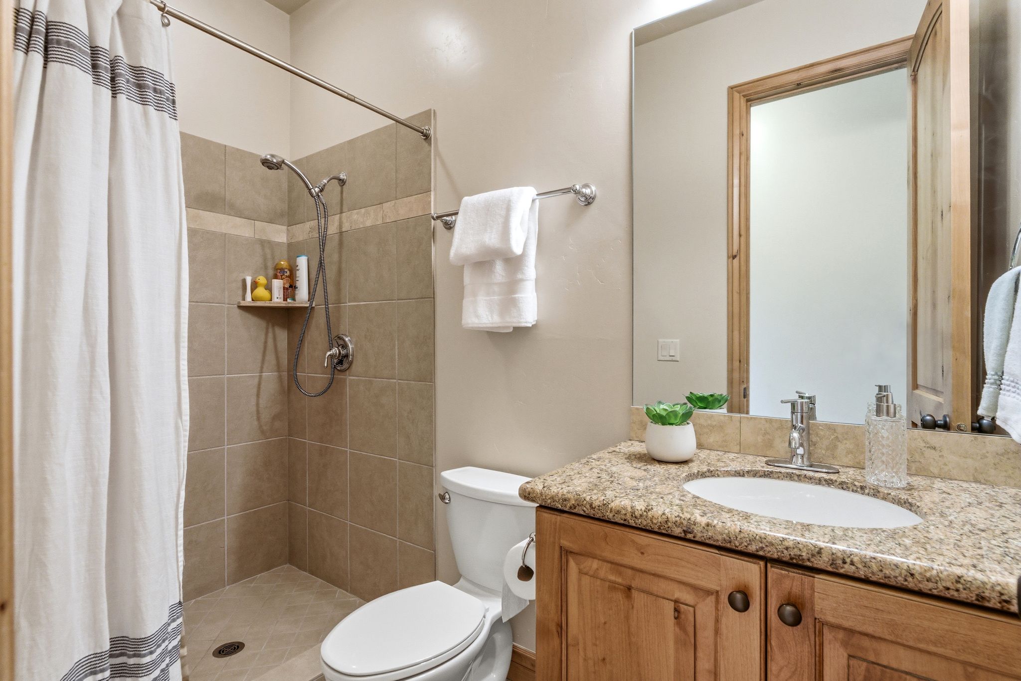 Full bath with a shower stall and vanity