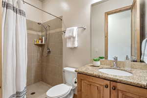 Full bath with a shower stall and vanity