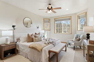 Bedroom with a ceiling fan and recessed lighting