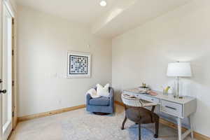 Carpeted office space with baseboards