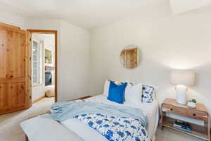 Carpeted bedroom featuring baseboards