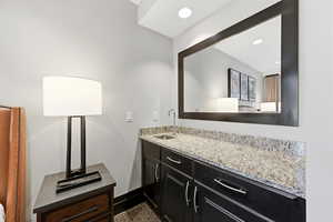 Bathroom featuring vanity and recessed lighting