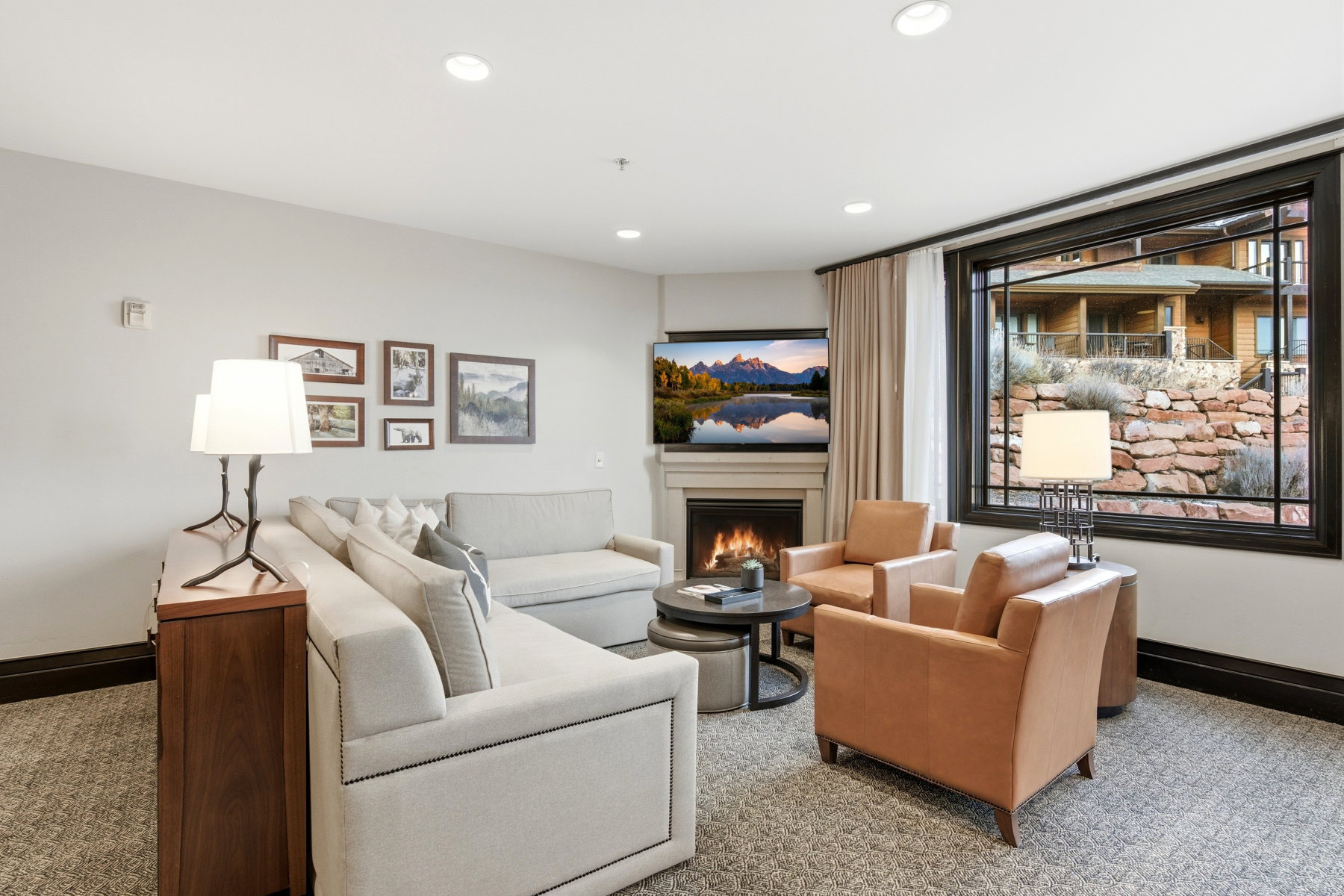 Living room featuring a lit fireplace, recessed lighting, and carpet