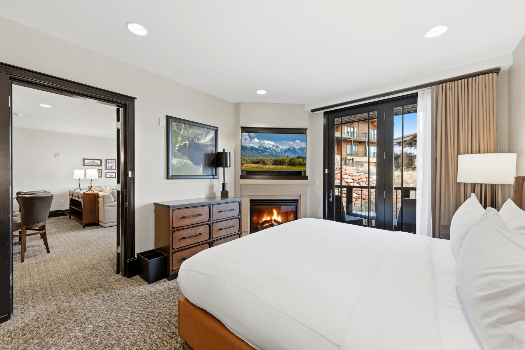 Bedroom with carpet, access to outside, and a glass covered fireplace
