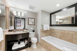 Full bath with vanity, a garden tub, light tile patterned flooring, and recessed lighting